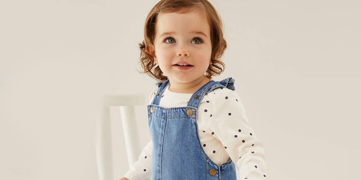 Baby wearing dungarees and long-sleeved top. Shop outfits